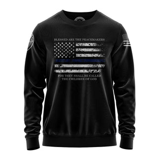 "Sweatshirt featuring 'Blessed are the Peace Makers' inspirational text and patriotic graphic design."