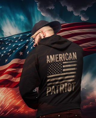 "A vibrant firework display illuminates the background, highlighting a massive USA flag. In the foreground, a man dons a patriotic hoodie adorned with the USA flag, embodying the spirit of an American patriot."